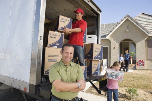 Staff handling packed boxes with care during a removals job