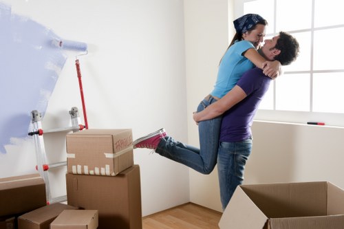 Local movers carrying furniture through a Haringey residential street
