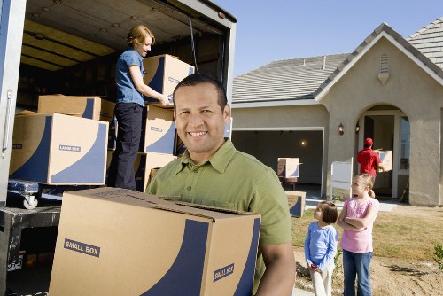 Professional movers loading household items for transport in North London